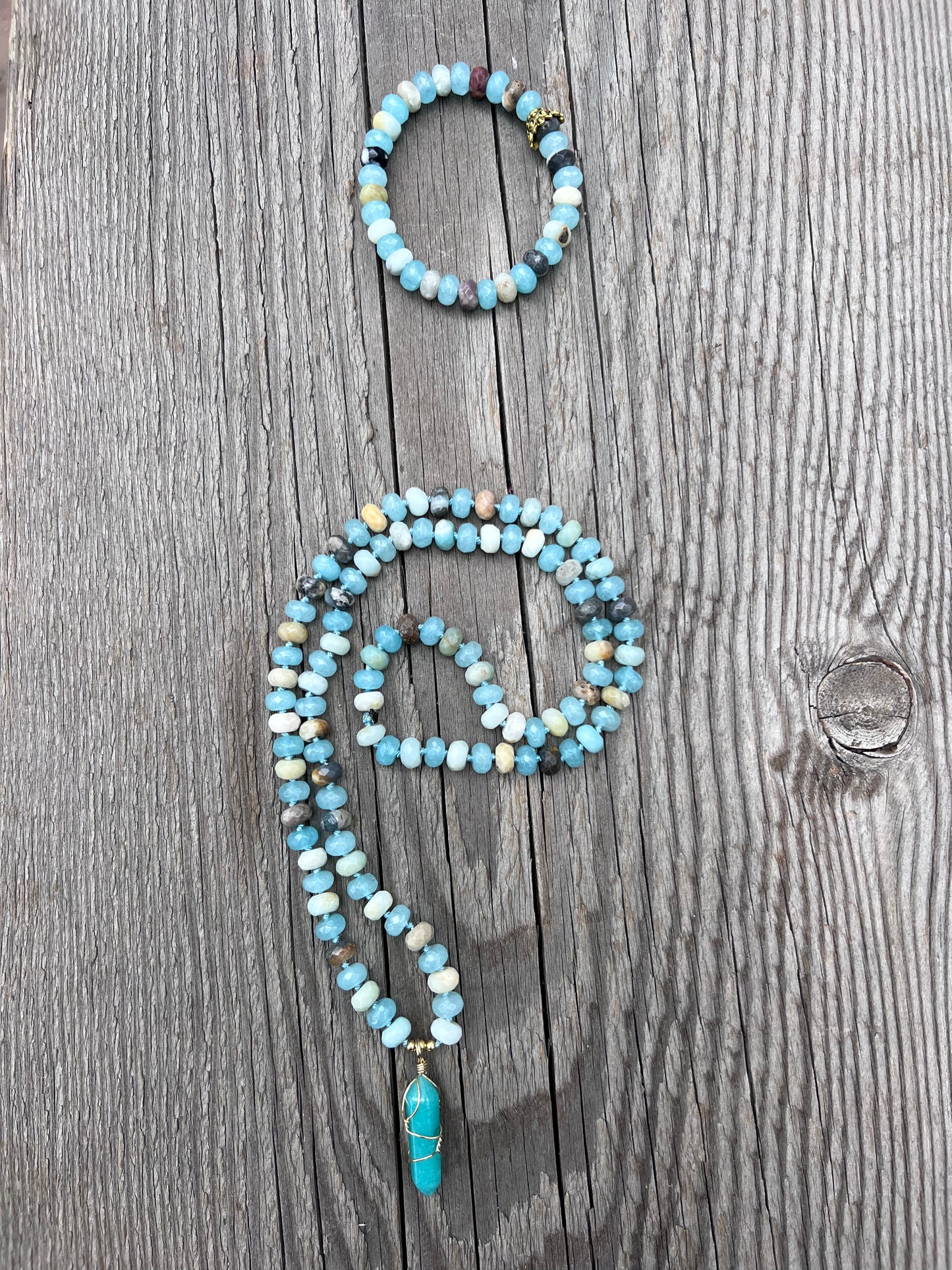 Amazonite and quartz pendant mala. Brass beads and wire. Moving towards liberation and light.￼