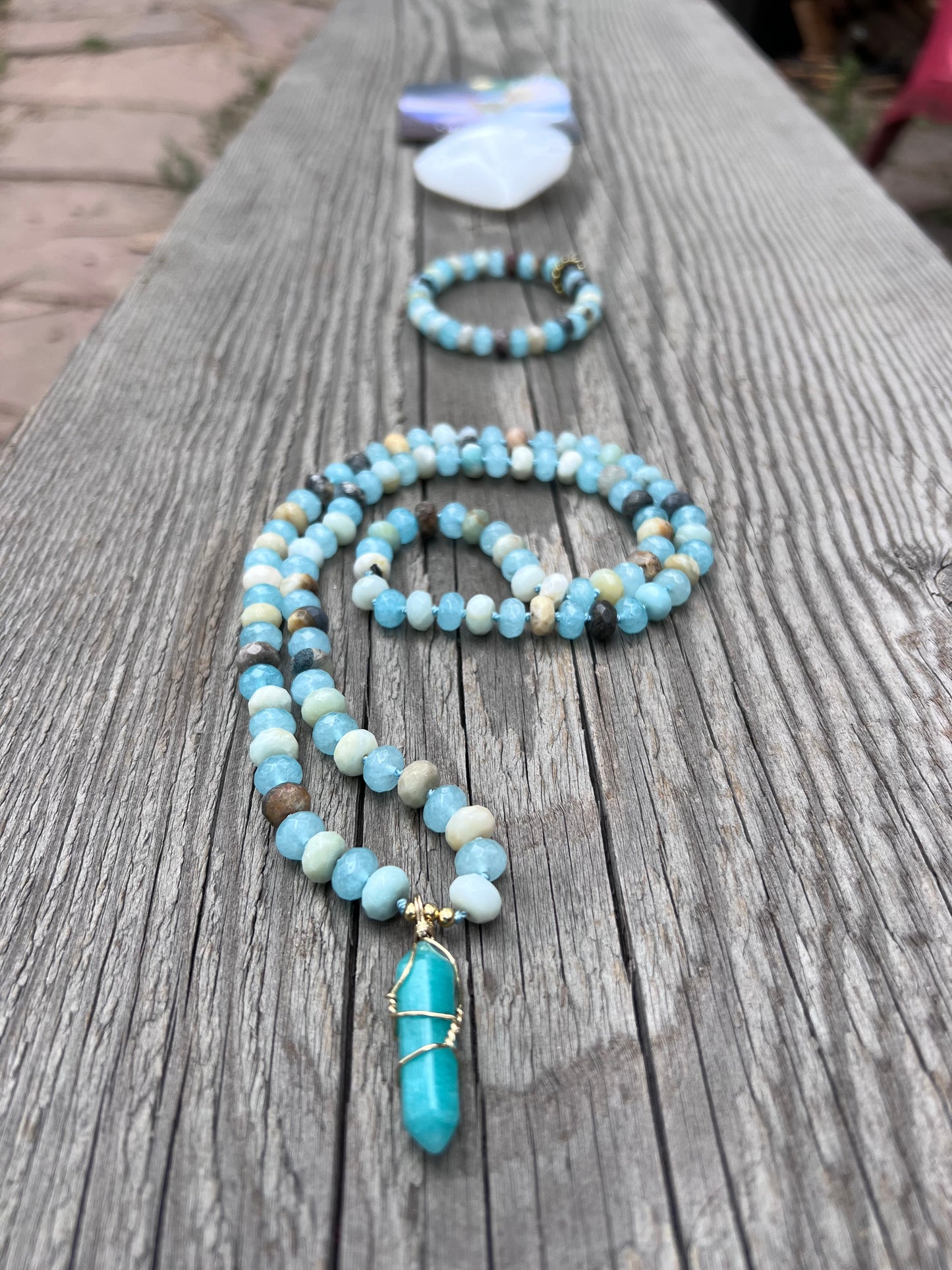 Amazonite and quartz pendant mala. Brass beads and wire. Moving towards liberation and light.￼