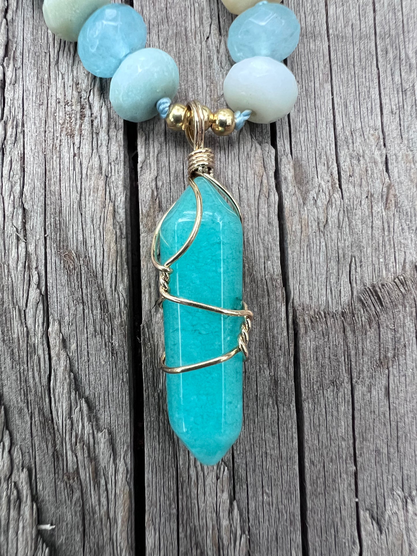 Amazonite and quartz pendant mala. Brass beads and wire. Moving towards liberation and light.￼